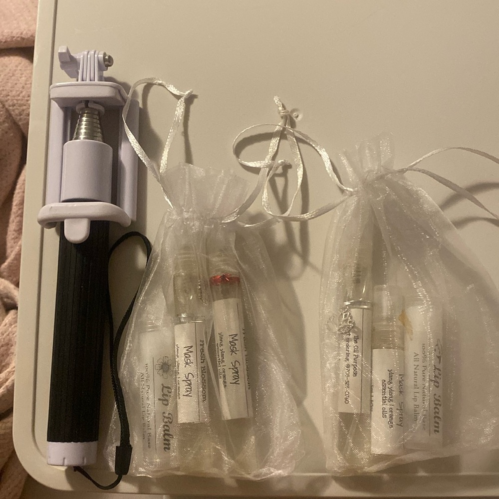Selfie Stick. 2 lip balms. 4 orange mask sprays/air mister. In mesh bags